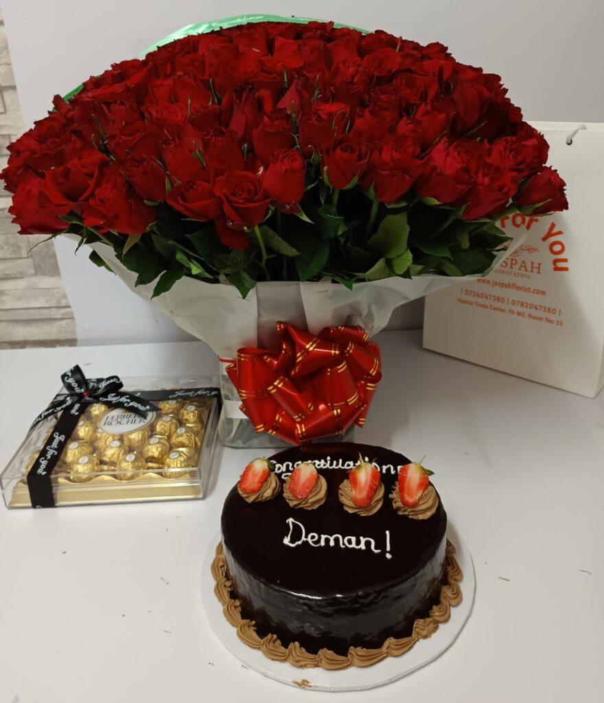 Red flowers bouquet, chocolates and cake
