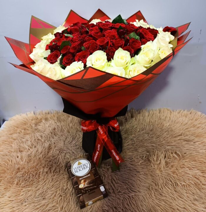 Bouquet of red and yellow roses and a chocolate