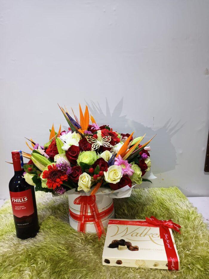 Flowers in a Vase, Red Wine and Walkers Chocolates