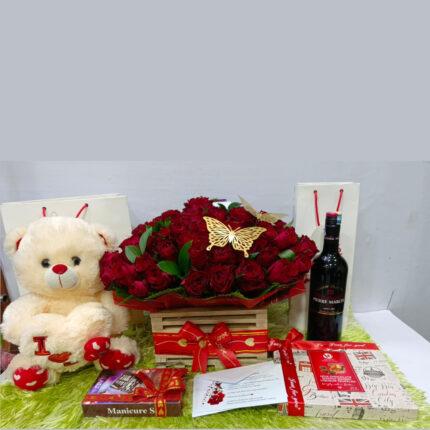Love gift hamper with red roses, teddy bear, wine and chocolates – perfect romantic gift