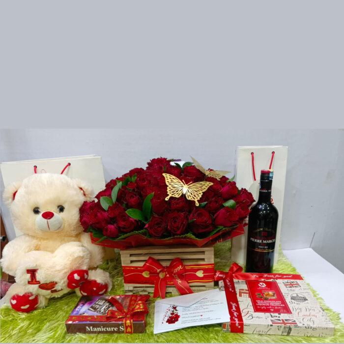 Love gift hamper with red roses, teddy bear, wine and chocolates – perfect romantic gift